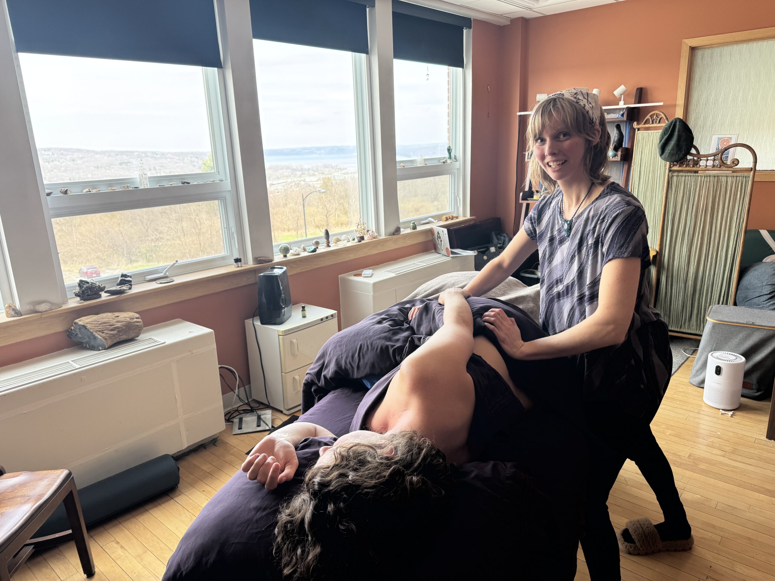 Victoria Anchor LMT performs a massage on a side lying client