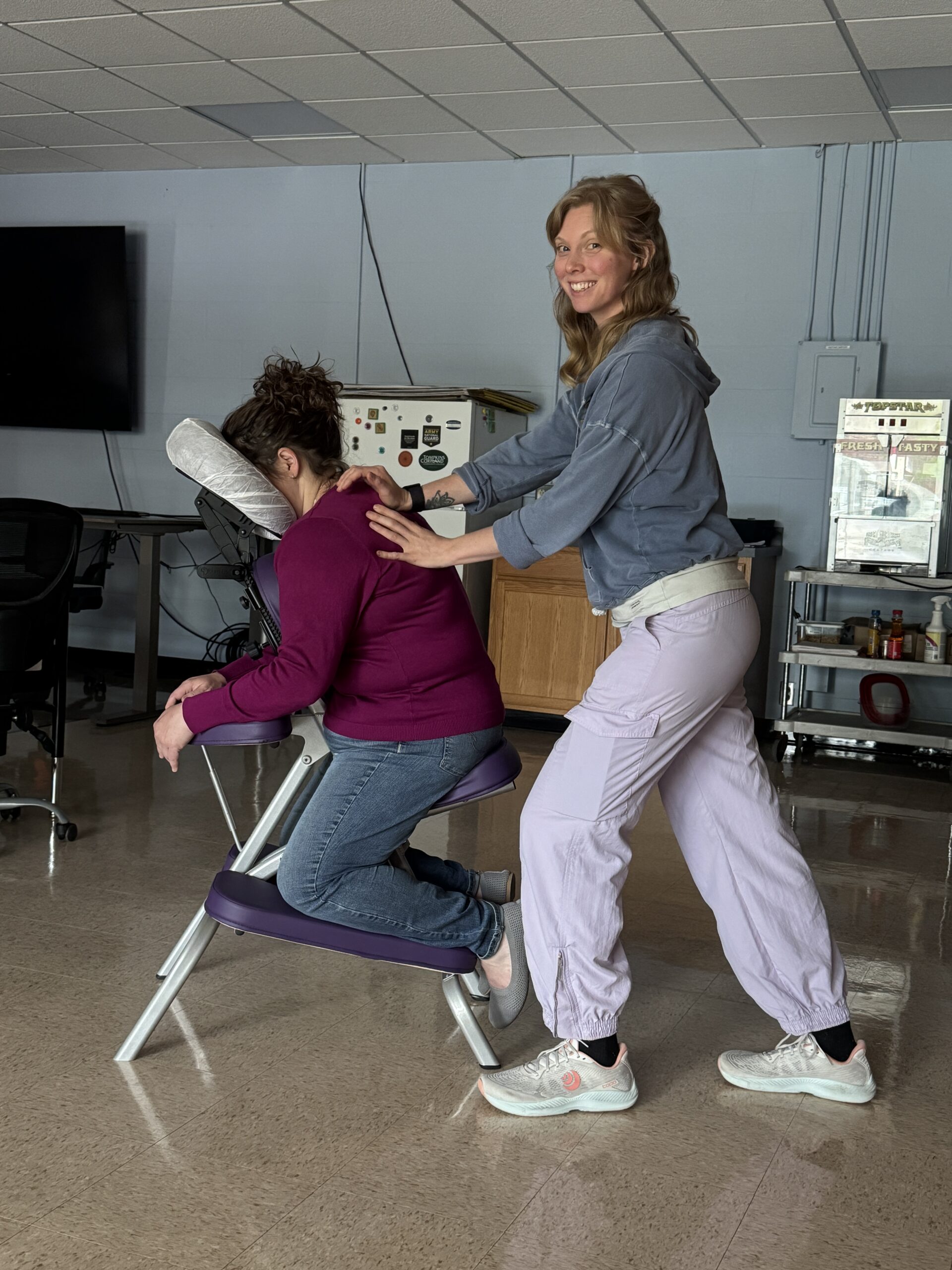 Victoria Anchor  LMT doing chair massage at an in office event